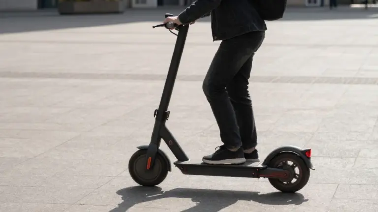 Adult riding an electric scooter in a modern city